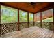 Inviting screened patio with wooden flooring and lattice railing, perfect for relaxing outdoors at 4050 Old Fairburn Rd, Atlanta, GA 30349