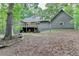View of the home's backyard featuring a deck and lush greenery at 4490 Highway 138 Sw, Stockbridge, GA 30281