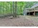 Backyard view of home exterior, deck, and surrounding trees at 4490 Highway 138 Sw, Stockbridge, GA 30281