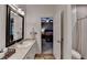 This spacious bathroom with tile floors offers a bedroom view, modern sink, and neutral finishes at 4490 Highway 138 Sw, Stockbridge, GA 30281