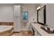 Bathroom features a soaking tub, white cabinets, spacious countertop, and large mirror at 4490 Highway 138 Sw, Stockbridge, GA 30281