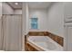 Bathroom features a tiled soaking tub, white cabinets and a shower at 4490 Highway 138 Sw, Stockbridge, GA 30281