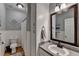 This bathroom features a large mirror, modern sink, wainscotting, and classic finishes at 4490 Highway 138 Sw, Stockbridge, GA 30281