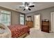 Carpeted bedroom offers natural light, ceiling fan, and connects to the bathroom at 4490 Highway 138 Sw, Stockbridge, GA 30281