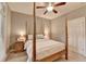 Cozy bedroom featuring a four-poster bed, ceiling fan, and neutral color palette at 4490 Highway 138 Sw, Stockbridge, GA 30281