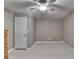 Bedroom features neutral colored walls and carpet with a ceiling fan for comfort at 4490 Highway 138 Sw, Stockbridge, GA 30281