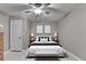 Bedroom with ceiling fan, and matching bedside tables with lamps, decorated in neutral tones at 4490 Highway 138 Sw, Stockbridge, GA 30281
