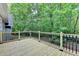 Spacious wooden deck overlooks a serene wooded backyard, perfect for outdoor entertaining at 4490 Highway 138 Sw, Stockbridge, GA 30281