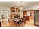 Dining area features hardwood floors, fireplace, and connects to kitchen with stainless appliances at 4490 Highway 138 Sw, Stockbridge, GA 30281