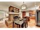 Charming dining room with fireplace, hardwood floors, and decorative light fixture at 4490 Highway 138 Sw, Stockbridge, GA 30281