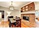 Inviting dining room featuring brick fireplace and hardwood floors at 4490 Highway 138 Sw, Stockbridge, GA 30281