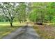 View of a long driveway surrounded by trees at 4490 Highway 138 Sw, Stockbridge, GA 30281