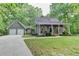 Charming home with a two-car garage, inviting front porch, and a well-maintained lawn at 4490 Highway 138 Sw, Stockbridge, GA 30281