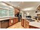 Open-concept kitchen with stainless steel appliances, wooden cabinets, and hardwood floors at 4490 Highway 138 Sw, Stockbridge, GA 30281