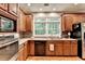 Well-lit kitchen with wooden cabinets, and stainless steel appliances at 4490 Highway 138 Sw, Stockbridge, GA 30281