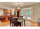 Open kitchen and dining area includes stainless appliances, hardwood floors, and access to the outdoor patio at 4490 Highway 138 Sw, Stockbridge, GA 30281