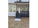 Exterior view of a newly constructed home with a covered back porch and stairs leading to the yard at 503 Glendale Rd, Scottdale, GA 30079