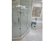 Elegant bathroom featuring a glass-enclosed shower with marble tile and a freestanding tub for a luxurious spa-like experience at 503 Glendale Rd, Scottdale, GA 30079
