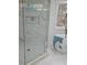 Elegant bathroom featuring a glass-enclosed shower with marble tile and a freestanding tub for a luxurious spa-like experience at 503 Glendale Rd, Scottdale, GA 30079