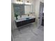 Modern bathroom with a sleek vanity, double sinks, and a large mirror, complemented by stylish lighting and fixtures at 503 Glendale Rd, Scottdale, GA 30079