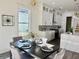Dining area with modern light fixtures, white cabinets, and contrasting countertops at 503 Glendale Rd, Scottdale, GA 30079