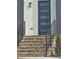 Stone steps with black railing leading up to a modern front door with glass panels at 503 Glendale Rd, Scottdale, GA 30079