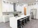 Bright, modern kitchen with a large island, stainless steel appliances, and pendant lighting at 503 Glendale Rd, Scottdale, GA 30079