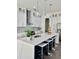 Bright, modern kitchen with white cabinetry, stainless steel appliances, a large island, and pendant lighting at 503 Glendale Rd, Scottdale, GA 30079