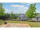 Inviting backyard with stone patio, lush lawn, and secure wrought iron fencing at 5695 Overlook Station Dr, Suwanee, GA 30024