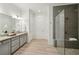 Beautiful bathroom featuring dual sinks and a tiled walk-in shower for a luxurious experience at 5695 Overlook Station Dr, Suwanee, GA 30024