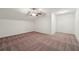 A bedroom with neutral colored carpet, natural light, and a ceiling fan at 5695 Overlook Station Dr, Suwanee, GA 30024