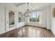 Elegant dining room featuring hardwood floors, stylish chandelier, and bright windows with scenic views at 5695 Overlook Station Dr, Suwanee, GA 30024