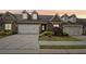 Inviting townhome with a two-car garage and well-maintained landscaping for a welcoming curb appeal at 5695 Overlook Station Dr, Suwanee, GA 30024