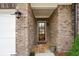 Inviting front entrance with brick surround, stone pavers, and decorative lighting at 5695 Overlook Station Dr, Suwanee, GA 30024