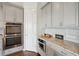 Modern kitchen with stainless steel double oven, granite counters and custom cabinetry at 5695 Overlook Station Dr, Suwanee, GA 30024