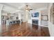 Open-concept living room with hardwood floors, coffered ceilings, and a cozy fireplace at 5695 Overlook Station Dr, Suwanee, GA 30024