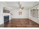 Bright living room features hardwood floors, fireplace, ceiling fan and is ready for you to make it your own at 5695 Overlook Station Dr, Suwanee, GA 30024