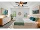 Light and airy main bedroom with tray ceilings and decor that welcomes you to rest and relax at 5695 Overlook Station Dr, Suwanee, GA 30024