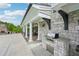 Covered outdoor patio with a built-in stone grill area, ideal for outdoor cooking and entertaining at 5695 Overlook Station Dr, Suwanee, GA 30024