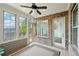 Charming sunroom featuring exposed brick, large windows, and a door to the exterior at 5695 Overlook Station Dr, Suwanee, GA 30024