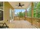 Spacious wooden deck with a ceiling fan, providing a comfortable outdoor space for relaxation and entertaining at 1180 Trident Maple, Lawrenceville, GA 30045