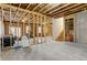 Unfinished basement showing exposed framing, offering potential for customization and additional living space at 1180 Trident Maple, Lawrenceville, GA 30045