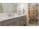 Bathroom with double sink vanity, white countertop, gray cabinets and floral shower curtain at 1180 Trident Maple, Lawrenceville, GA 30045
