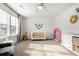 Bright Bedroom featuring a crib, changing table, and decorative lion wall decor, creating a cheerful space at 1180 Trident Maple, Lawrenceville, GA 30045