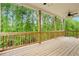 Large deck with ceiling fan overlooking a lush green forest, perfect for outdoor enjoyment at 1180 Trident Maple, Lawrenceville, GA 30045