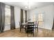 Dining room with hardwood floors, windows, and modern chandelier at 1180 Trident Maple, Lawrenceville, GA 30045