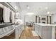 Modern kitchen featuring white cabinets, stainless steel appliances, and a large island with a sink at 1180 Trident Maple, Lawrenceville, GA 30045