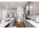Bright kitchen with white cabinetry, stainless steel appliances, and a center island with quartz countertops at 1180 Trident Maple, Lawrenceville, GA 30045