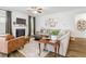 Cozy living room with fireplace, ceiling fan, and wood floors at 1180 Trident Maple, Lawrenceville, GA 30045
