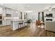 Open-concept living space featuring a modern kitchen, dining area, and cozy living room with hardwood floors at 1180 Trident Maple, Lawrenceville, GA 30045